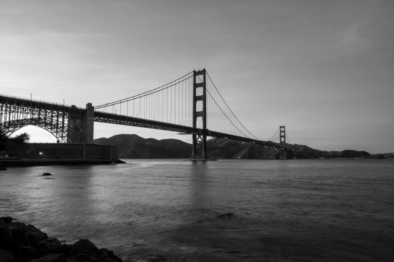 a black and white photo of the golden gate bridge, by Dave Melvin, pexels contest winner, fan favorite, high quality wallpaper, medium format, riverside