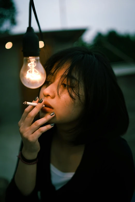 a woman smoking a cigarette next to a light bulb, a picture, unsplash, hyperrealism, young asian girl, a green, low iso, just