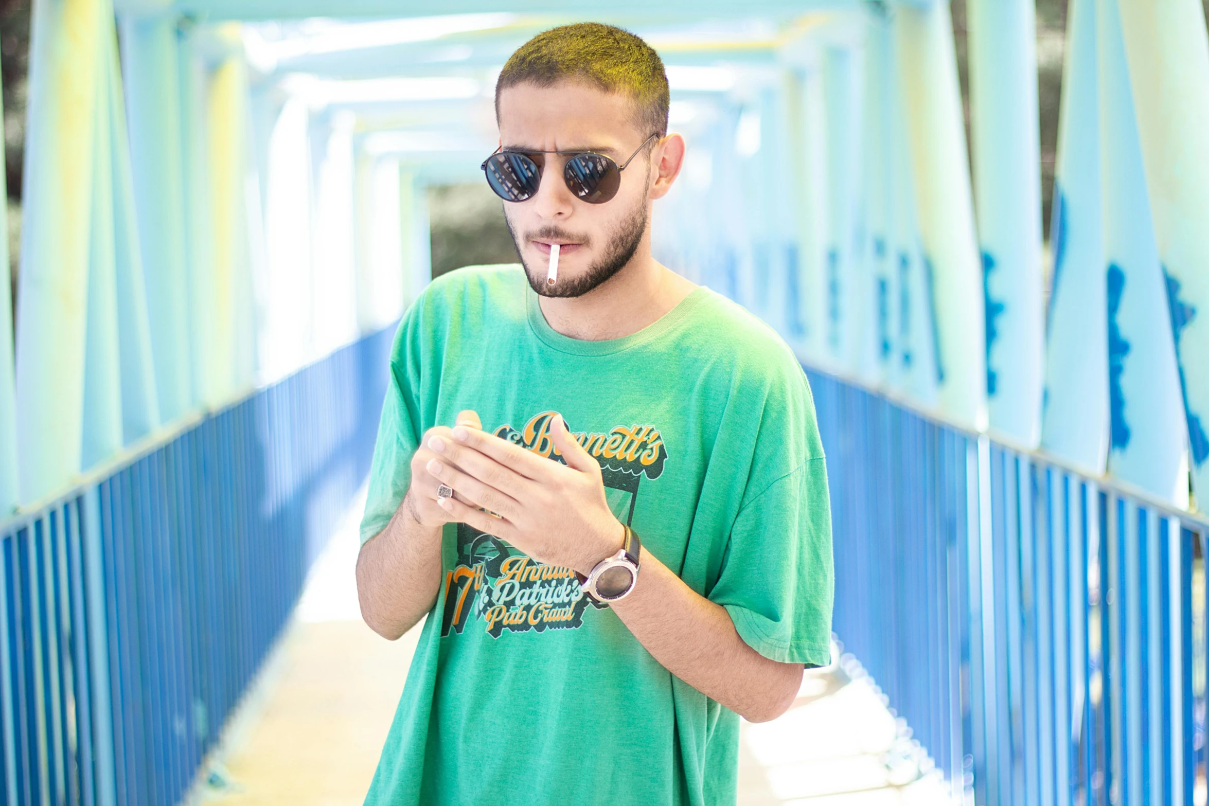 a man in a green shirt looking at his cell phone, pexels contest winner, les nabis, wearing shades, avatar image, mohamed chahin style, casual pose