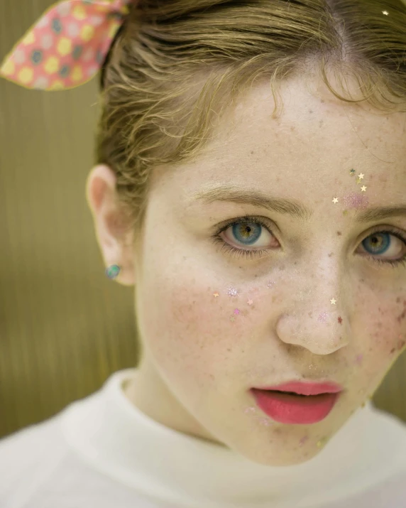 a close up of a woman with freckles on her head, an album cover, inspired by Hikari Shimoda, trending on pexels, beautiful taissa farmiga, a boy made out of gold, rainbow eyes, porcelain skin ”