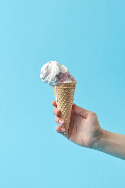 a person holding an ice cream cone in their hand, blue and pink shift, epicurious, uncrop, medium
