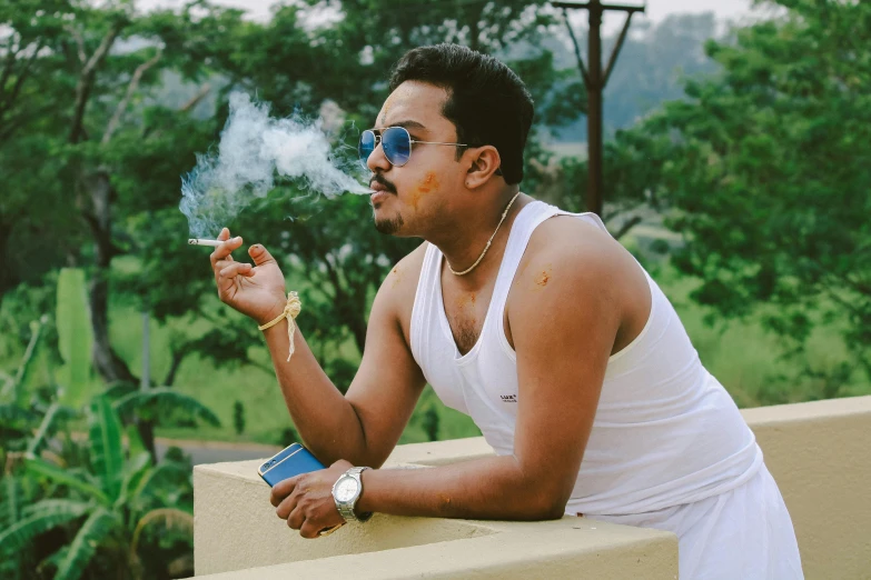 a man in a white tank top smokes a cigarette, pexels contest winner, assamese aesthetic, wearing shades, nug pic, profile image