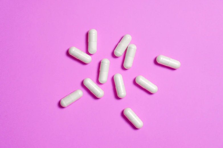 white pills on a pink background, trending on pexels, swirly tubes, implants, ivory skin, white neon