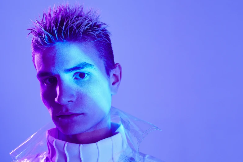 a close up of a person wearing a jacket, an album cover, inspired by Kristian Kreković, trending on pexels, blue lights and purple lights, people with mohawks, f 1 driver charles leclerc, glowing with colored light