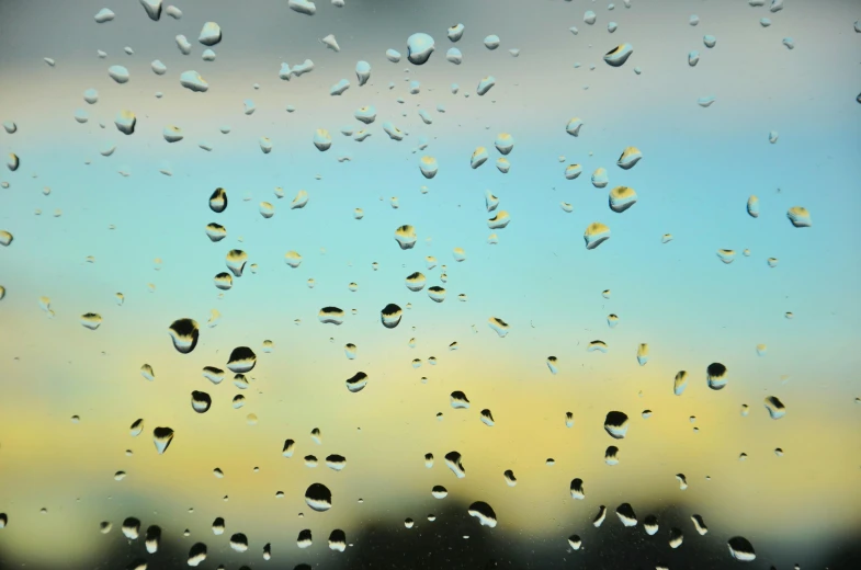 a bunch of drops of water on a window, an album cover, inspired by Elsa Bleda, unsplash, hyperrealism, blue - yellow sky, computer wallpaper, weather report, morning. hyperrealism