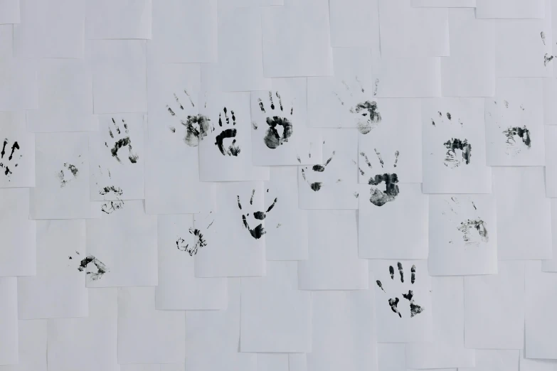 a bunch of hand prints on a wall, an ink drawing, trending on pexels, on vellum, 64x64, multiple small black eyes, wall paper