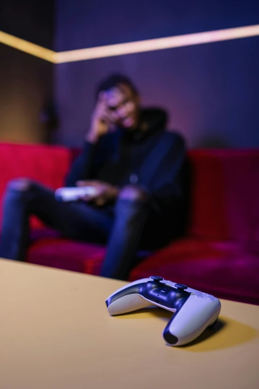 a remote control sitting on top of a table, by artist, pexels, video game avatar, with a sad expression, lgbtq, sitting in a lounge
