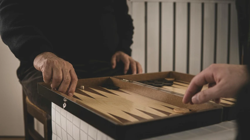 two men are playing a game of backgam, by Matthias Stom, unsplash, middle close up shot, bargello, matt finish, thumbnail