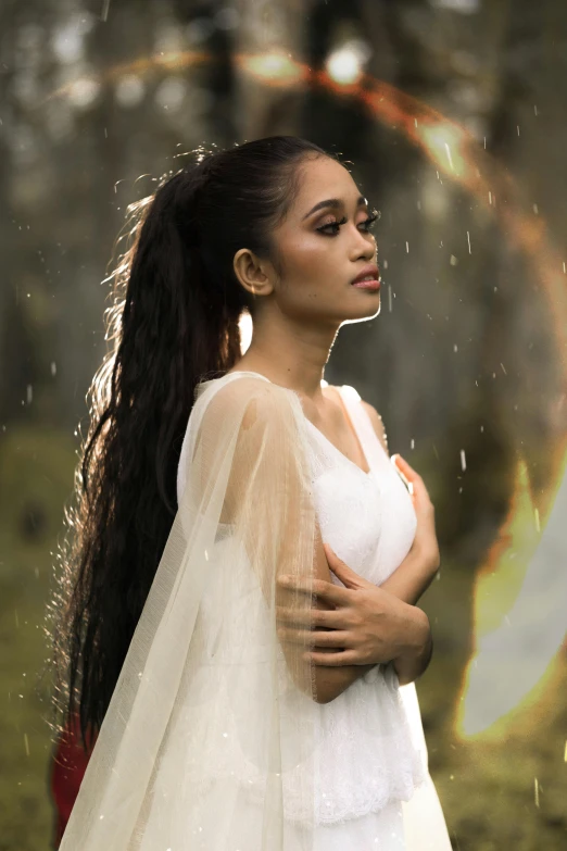 a woman in a white dress standing in the rain, an album cover, inspired by reyna rochin, sumatraism, handsome girl, fairy, hair, 2019 trending photo