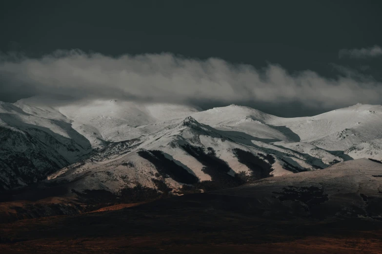 a snow covered mountain range under a cloudy sky, unsplash contest winner, hurufiyya, it's getting dark, background image, volcanic embers, 4 k hd wallpapear