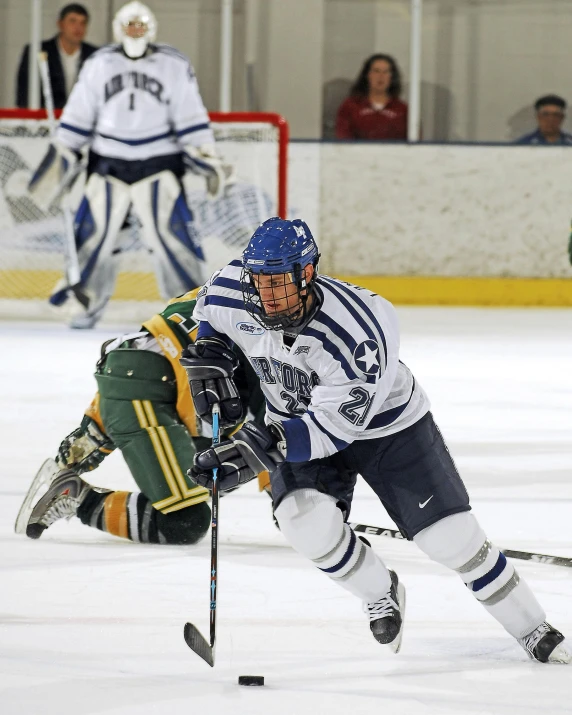 a group of young men playing a game of hockey, a photo, flickr, confident looking, blue, college, “hockey team logo