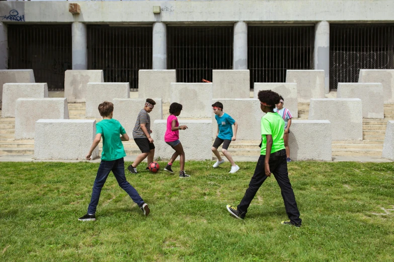 a group of young men playing a game of soccer, an album cover, by Michael Goldberg, pexels contest winner, figuration libre, brutalist courtyard, kids playing, washington dc, 15081959 21121991 01012000 4k
