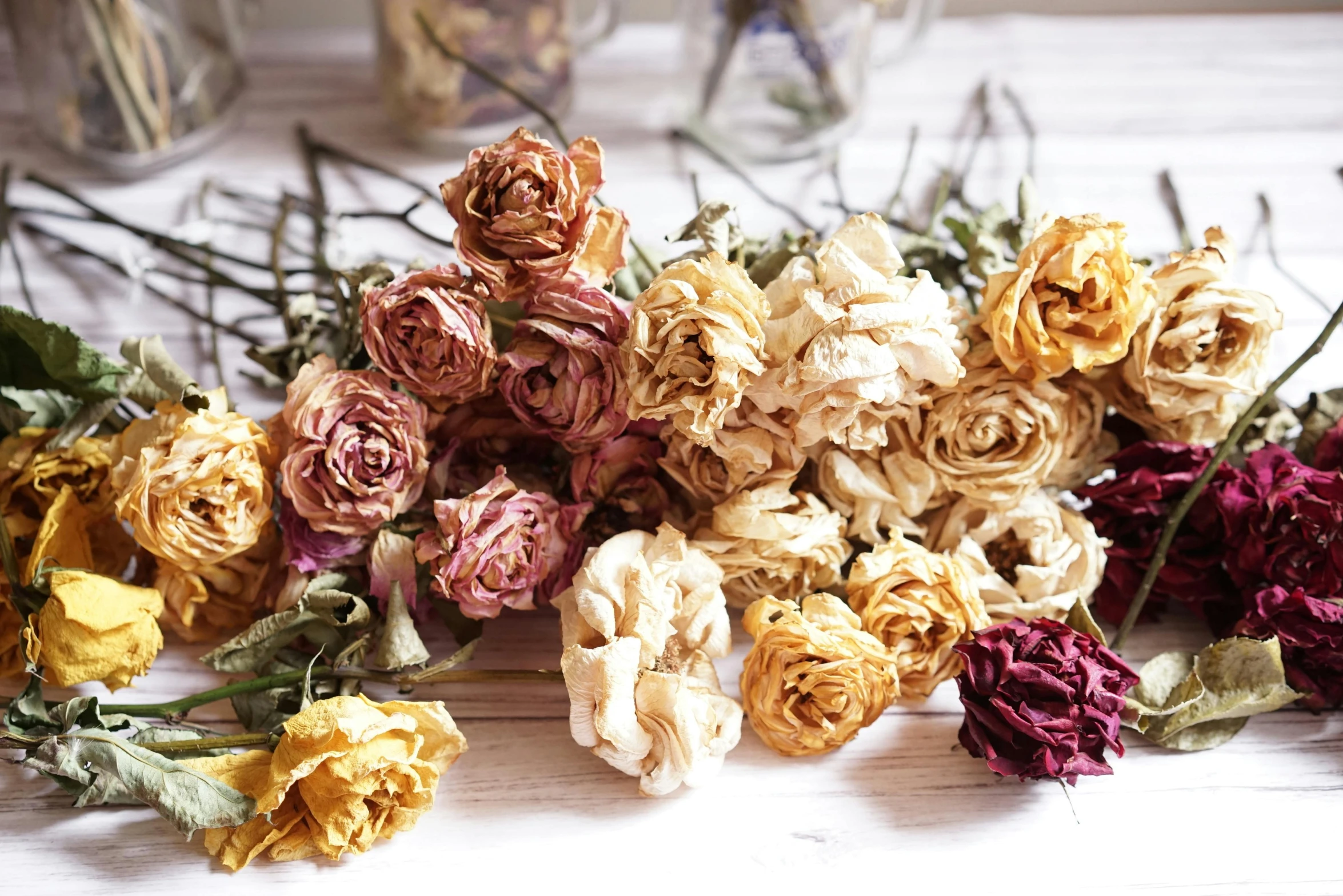 a bunch of dried flowers on a table, natural point rose', yellows and reddish black, mid-30s, natural colours