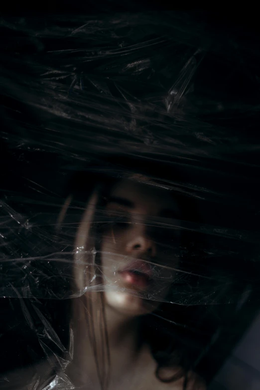 a woman holding a black umbrella over her head, inspired by Elsa Bleda, inside head cobwebs, infp young woman, dark face, person made out of glass