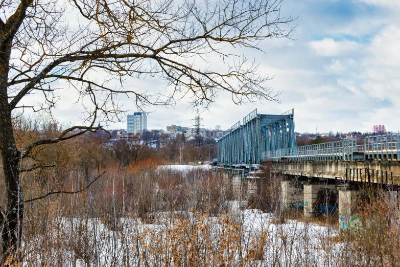 a train traveling over a bridge over a river, by Mathias Kollros, pexels contest winner, graffiti, winter forest, soviet brutalism, city panorama, 000 — википедия