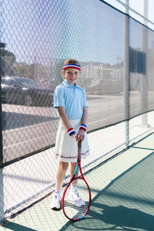 a young boy holding a tennis racquet on a tennis court, a portrait, unsplash, american barbizon school, dressed as schoolgirl, patriotic, pastel', lookbook