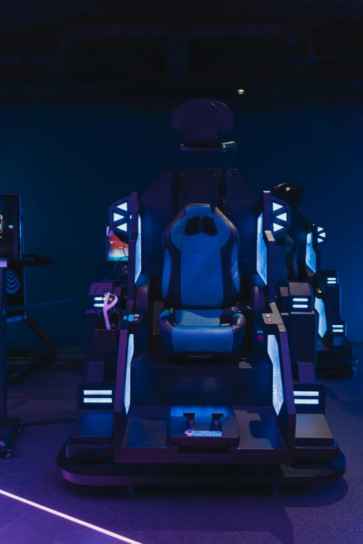 a group of video game machines sitting next to each other, seated on a throne, robotic arms, blue room, immersive