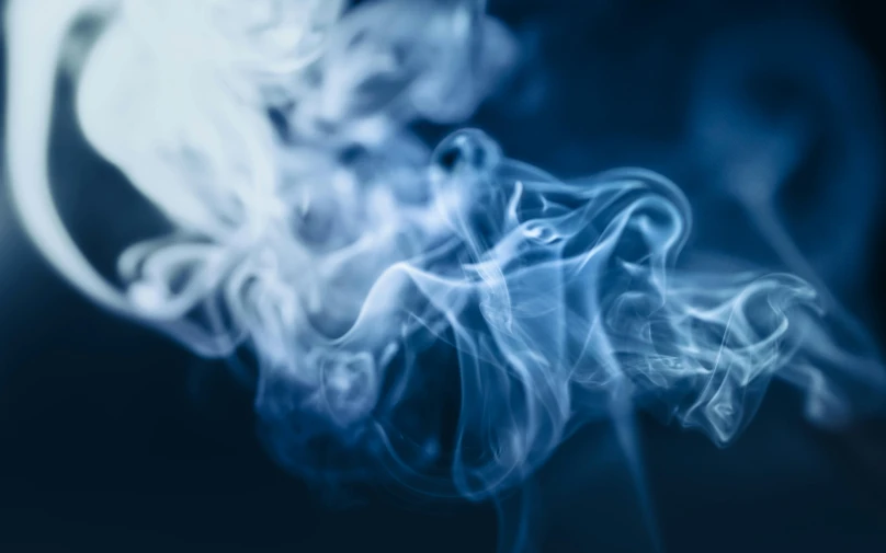 a close up of smoke on a black background, pexels contest winner, desaturated blue, trailing white vapor, weed background, on blue fire