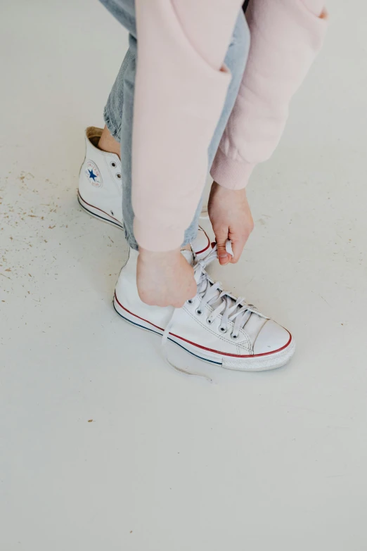 a close up of a person tying a shoe, girl standing, converse, curated collections, kids