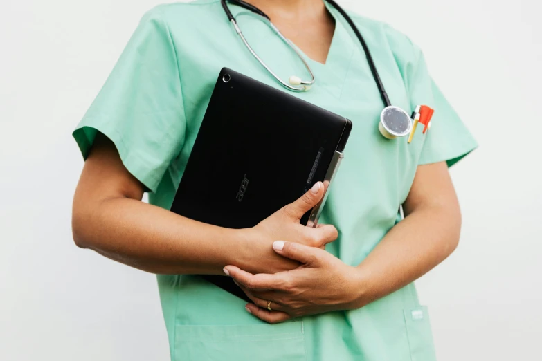 a nurse holding a tablet computer and a stethoscope, by Emma Andijewska, pexels, 3/4 side view, black, a green, small in size