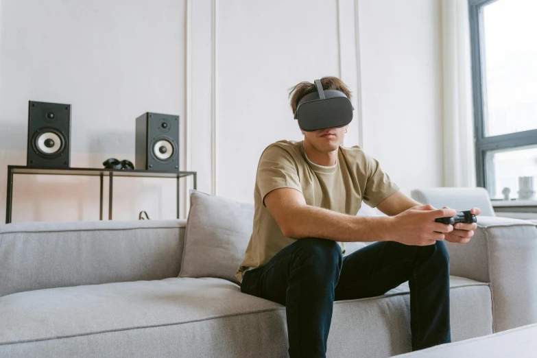 a man sitting on a couch using a cell phone, an album cover, trending on pexels, hyperrealism, vr helmet on man, unreal engine generation, oled visor over eyes, cardboard