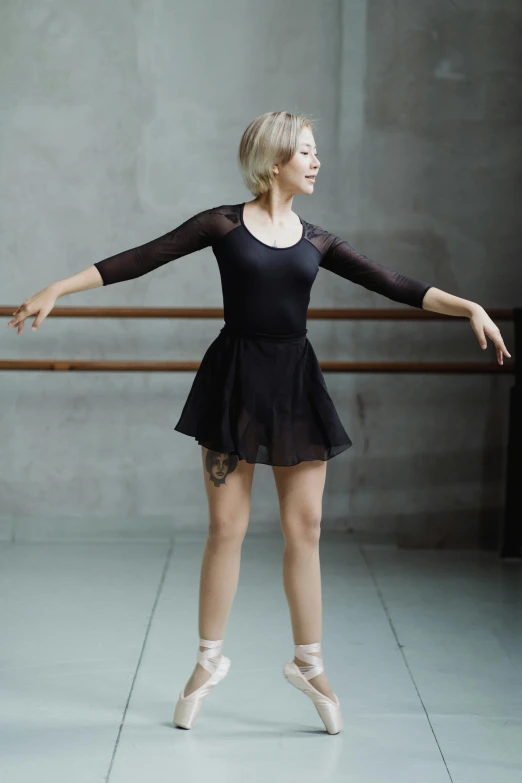 a woman in a black dress is doing a ballet pose, pexels contest winner, hand on hips, sydney sweeney, 15081959 21121991 01012000 4k, 2 arms and 2 legs