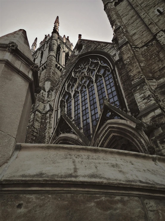 a very tall building with a clock on it's side, a photo, pexels contest winner, international gothic, dark gloomy church, deep crevices of stone, today\'s featured photograph 4k, upon a peak in darien