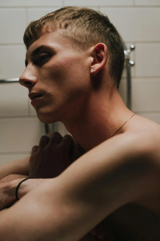 a man taking a picture of himself in the mirror, an album cover, by Jessie Alexandra Dick, trending on pexels, masculine jawline, nonbinary model, lights, shaved