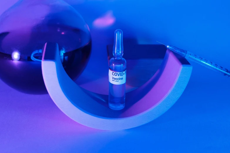 a bottle of alcohol sitting on top of a table, inspired by Évariste Vital Luminais, bauhaus, blue and purple lighting, surgical iv drip, product view, beautifier