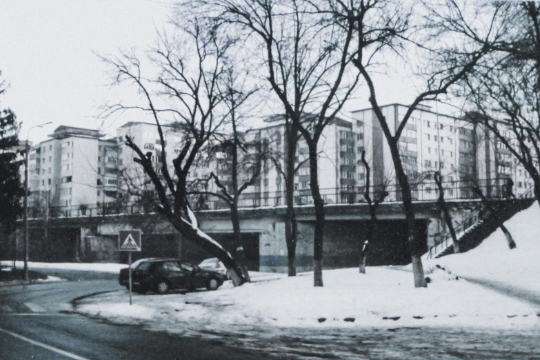 a black and white photo of a snow covered street, a black and white photo, bauhaus, soviet apartment buildings, 1990s photograph, 35mm —w 1920 —h 1080, old color photograph