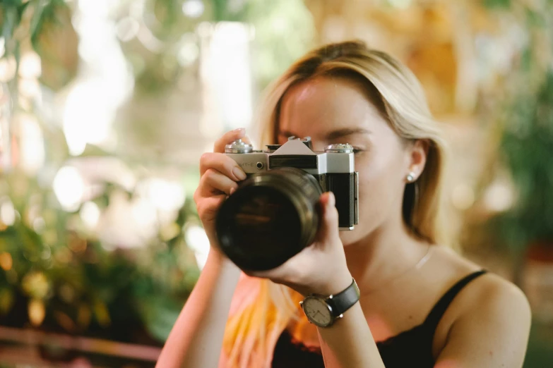 a woman taking a picture with a camera, pexels contest winner, sydney sweeney, avatar image, zoomed in shots, medium format