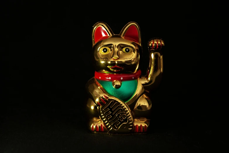 a gold cat figurine on a black background, a statue, by Julia Pishtar, pexels contest winner, cloisonnism, 3d model of a japanese mascot, taken on a 1960s kodak camera, hindu god, thumbnail