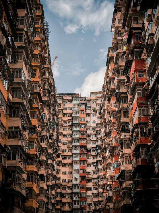 a street filled with lots of tall buildings, by Patrick Ching, pexels contest winner, hyperrealism, buildings covered with greebles, like jiufen, soviet apartment buildings, brutalism buildings