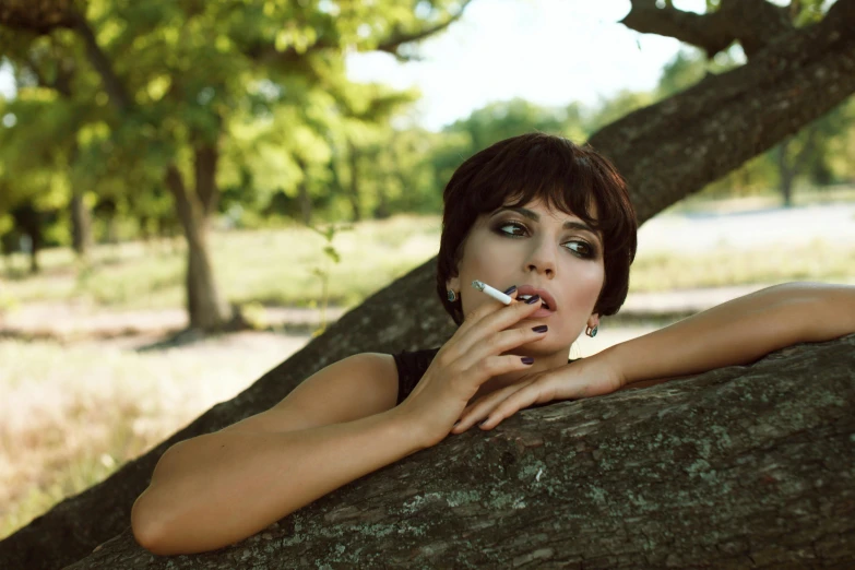 a woman leaning on a tree with a cigarette in her mouth, inspired by Elsa Bleda, pexels contest winner, renaissance, short brown hair and large eyes, maxim sukharev, smoker, alice cullen