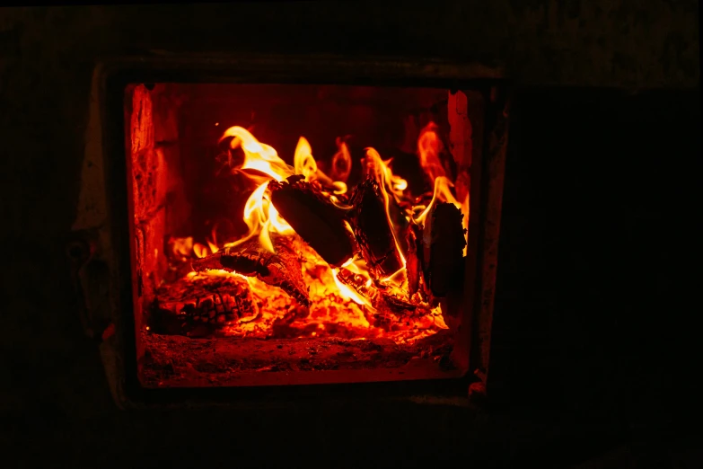 a close up of a fire in a brick oven, pexels contest winner, light inside the hut, glowing red, a wooden