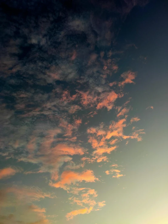 a man flying a kite on top of a lush green field, a picture, unsplash, romanticism, dramatic pink clouds, ((sunset)), today\'s featured photograph 4k, sky night