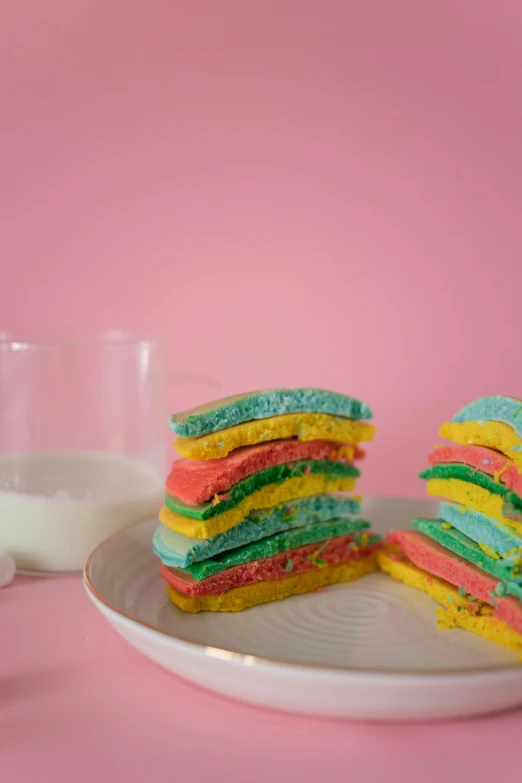 a stack of colorful cookies on a plate next to a glass of milk, by Julia Pishtar, color field, marshmallow graham cracker, modeled, reverse, 2 5 6 x 2 5 6 pixels