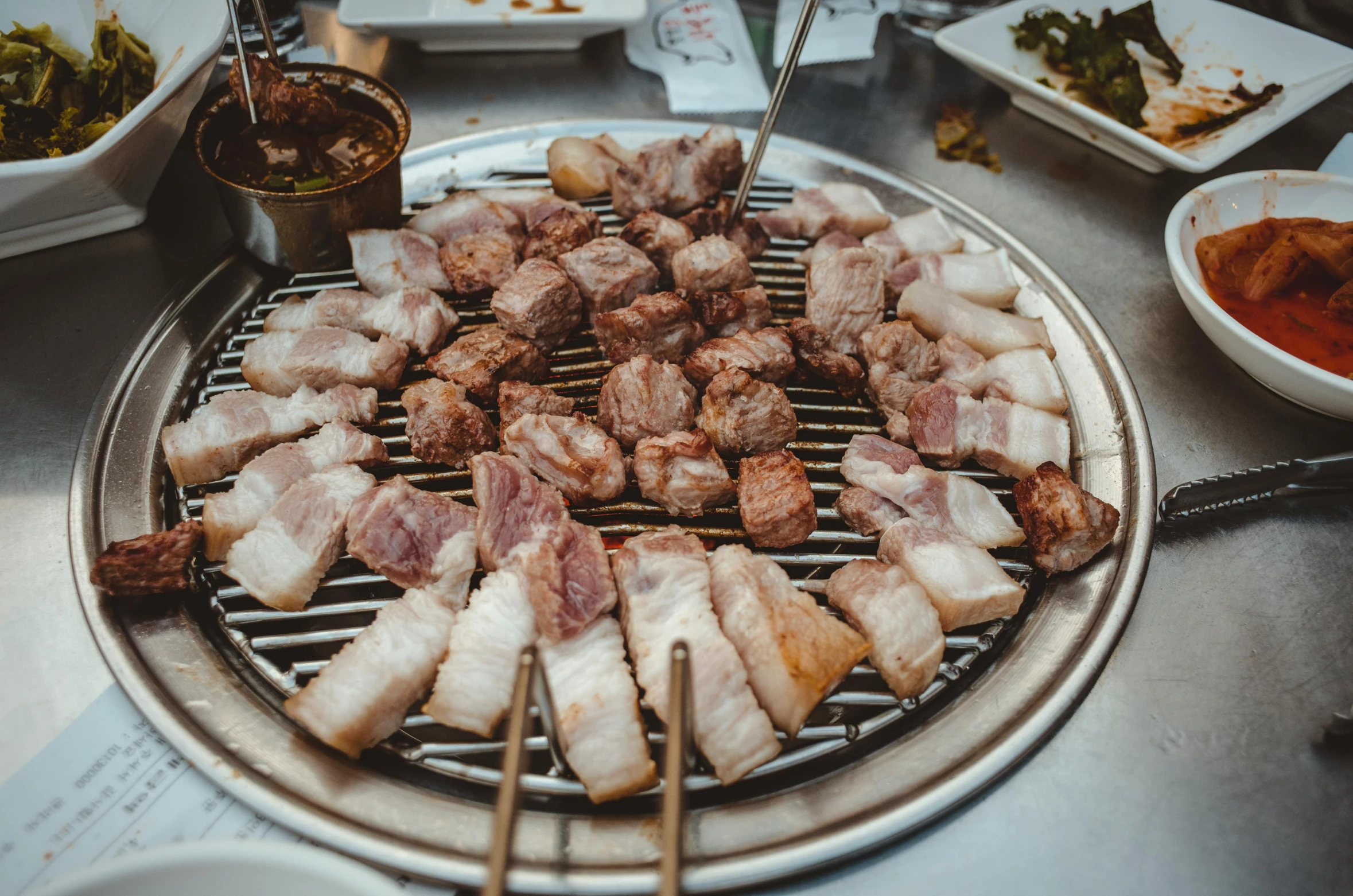 a bunch of food that is on a grill, mingei, grey, round, thumbnail, korean