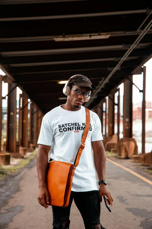 a man riding a skateboard down a street, an album cover, inspired by Barthélemy Menn, unsplash contest winner, white t-shirt, holding a leather purse, looking content, michal