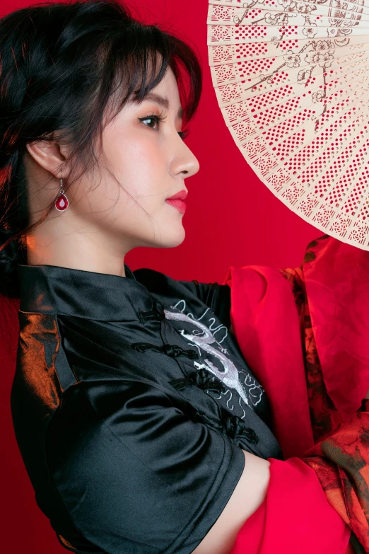 a woman in a red dress holding a white umbrella, an album cover, inspired by Zhang Yin, profile image, wearing black silk robe, ( ( theatrical ) ), vietnamese woman