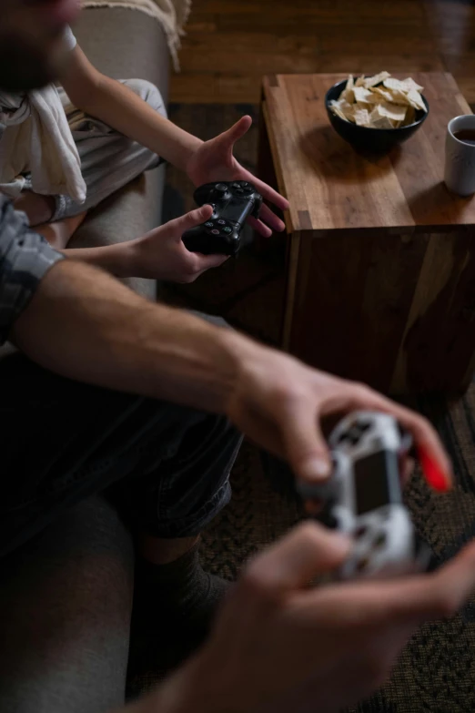 a couple of people sitting on a couch playing a video game, by Adam Marczyński, unsplash, high angle shot, playstion 5 screen, ( ultra realistic, hands