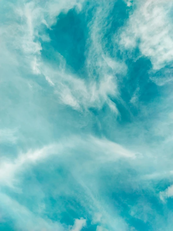 a plane flying through a cloudy blue sky, by Carey Morris, pexels contest winner, minimalism, gradient cyan, face made out of clouds, today\'s featured photograph 4k, cloud nebula