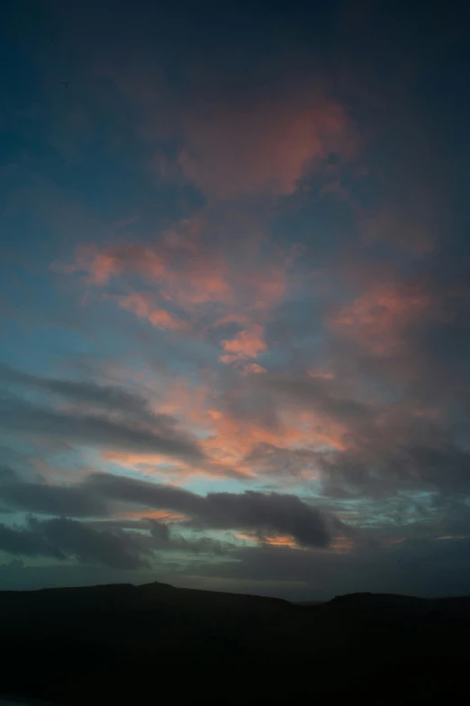 a large body of water under a cloudy sky, by Doug Ohlson, romanticism, beautiful new mexico sunset, face in the clouds, atmospheric photograph, pink and blue and green mist