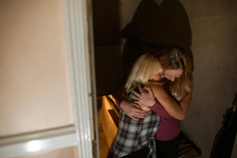 a couple of women standing next to each other, inspired by Nan Goldin, pexels, happening, hugging her knees, an escape room in a small, a blond, 15081959 21121991 01012000 4k