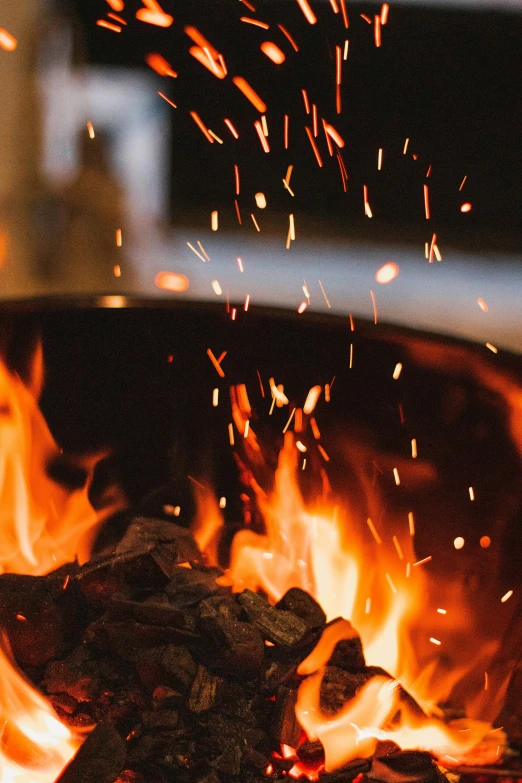 a close up of a fire with sparks coming out of it, cozy setting, “ iron bark, promo image, braziers