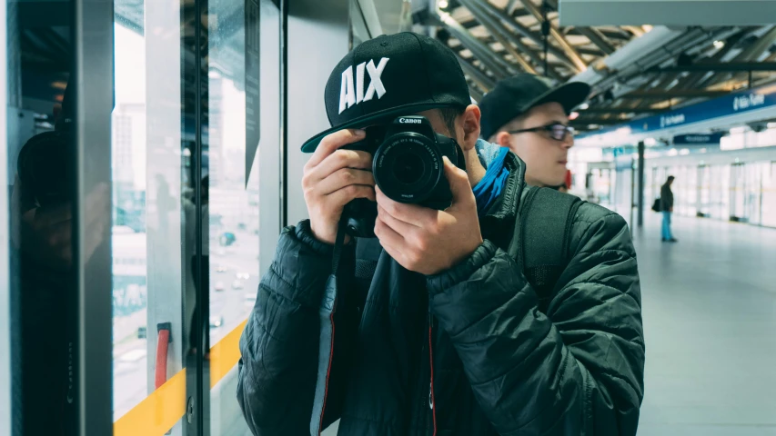 a man taking a picture of himself with a camera, a picture, by Adam Rex, pexels contest winner, wearing a baseball hat, shot on arri alexa, streetwear, profile pic