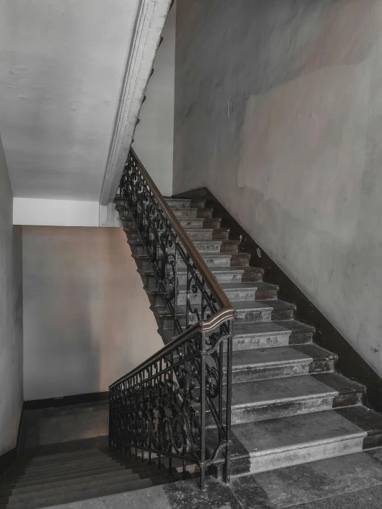 a black and white photo of a staircase, an album cover, inspired by Thomas Struth, pexels contest winner, art nouveau, desaturated color, soviet apartment building, desaturated!!, background image