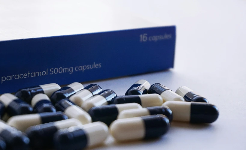 a bunch of pills sitting on top of a table, dark blue and white robes, still in package, black on white background, highly capsuled