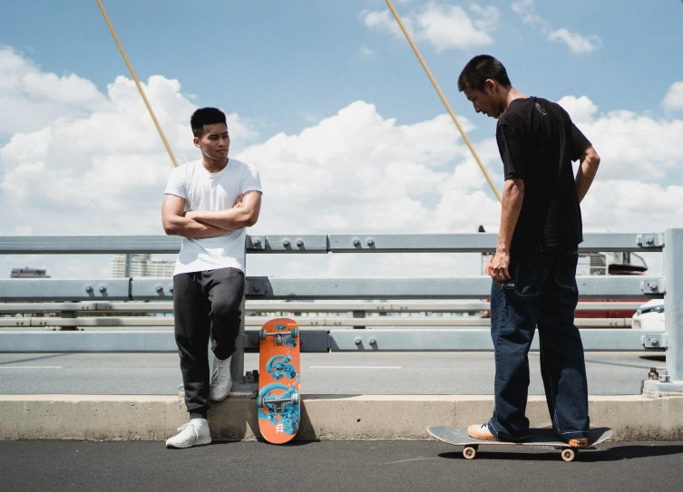 two men standing next to each other on a bridge, pexels contest winner, detailed skateboard, zeen chin and terada katsuya, cardistry, bowater charlie and brom gerald