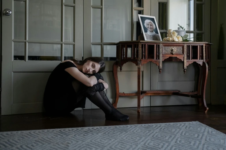 a woman sitting on the floor in a room, a portrait, pexels contest winner, antipodeans, mourning family, portrait of emma watson, 15081959 21121991 01012000 4k, sydney hanson